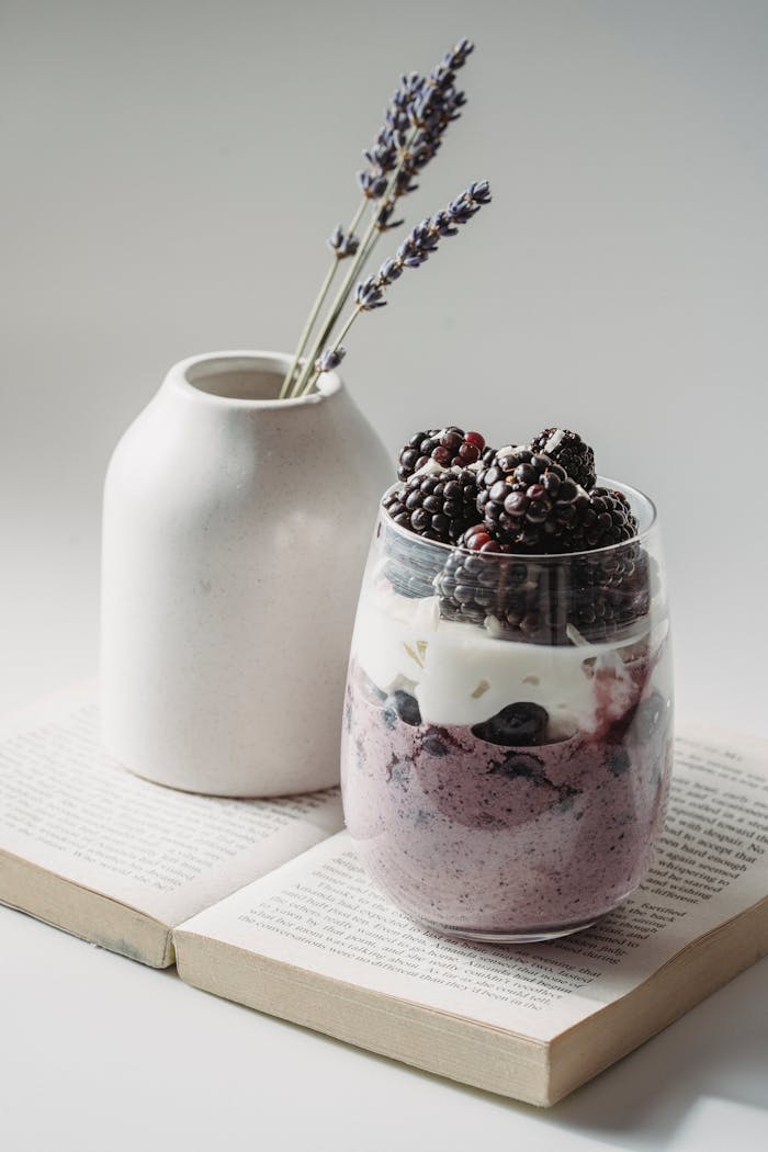 Stylish blackberry yogurt parfait with lavender in a minimalist setup, ideal for breakfast inspiration.